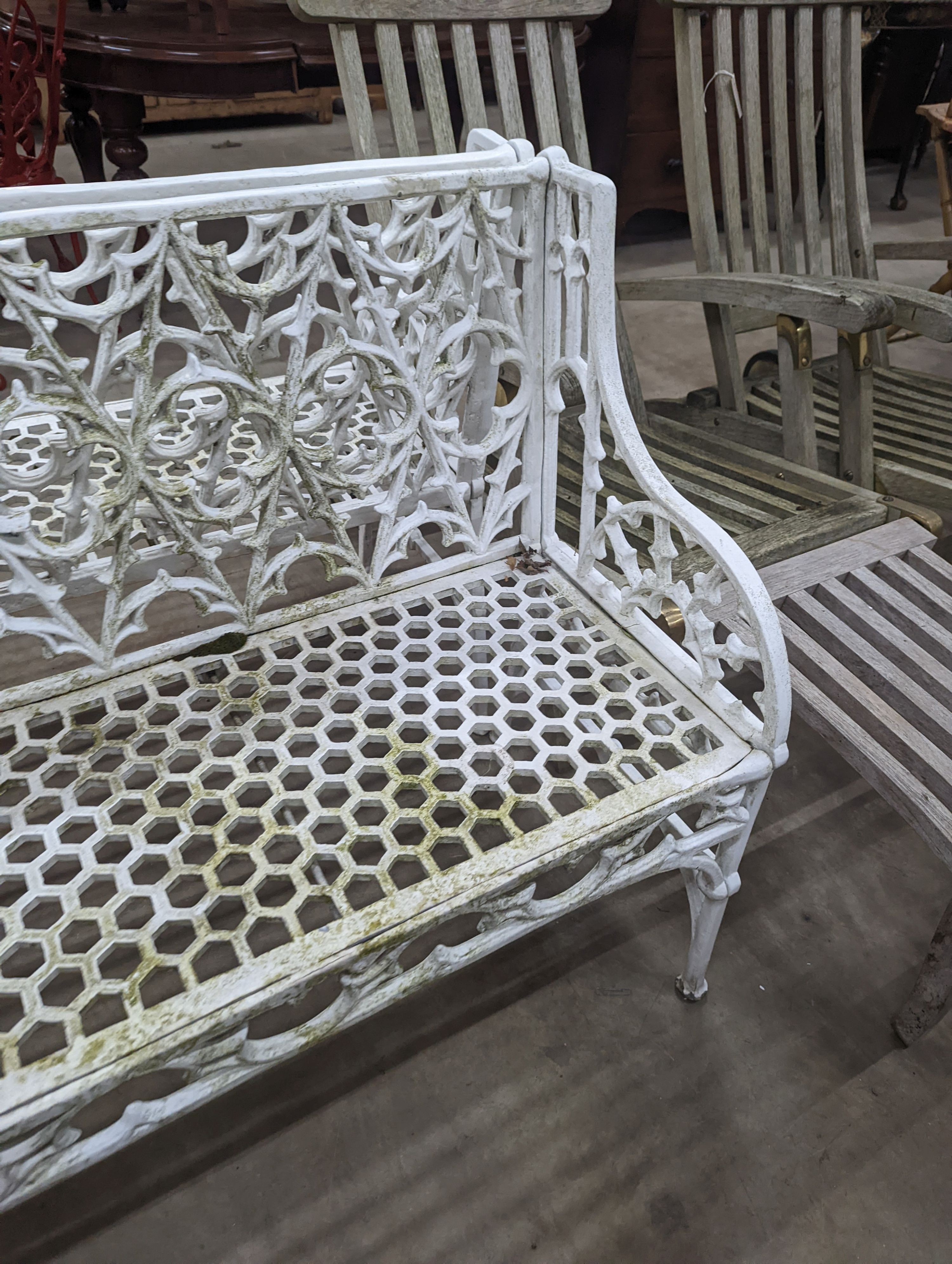 A pair of Victorian style painted cast metal garden benches, length 138cm, depth 44cm, height 86cm